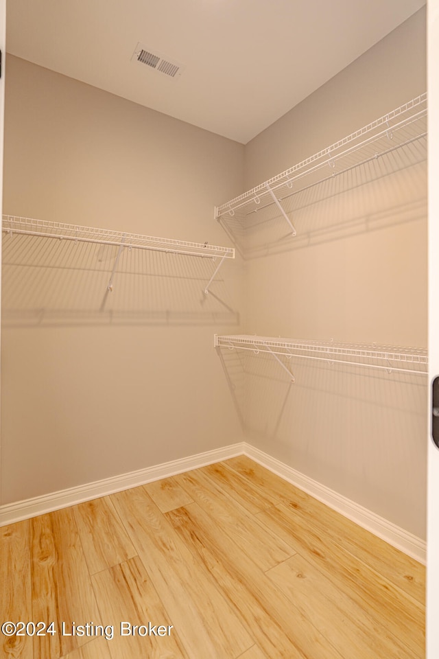 spacious closet featuring hardwood / wood-style flooring