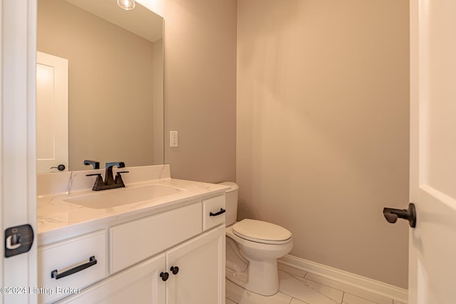 bathroom featuring tile patterned floors, vanity, and toilet