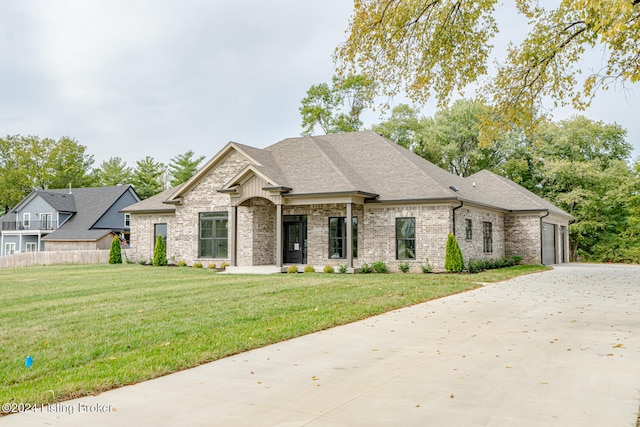 view of front of home featuring a front yard and a garage