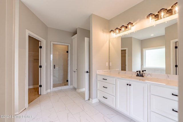 bathroom featuring an enclosed shower and vanity