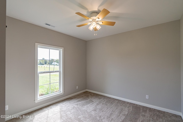 carpeted spare room featuring ceiling fan