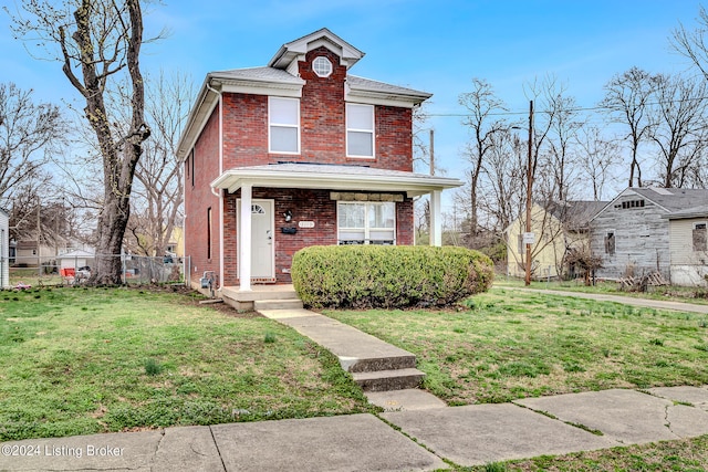 view of property featuring covered porch and a front lawn