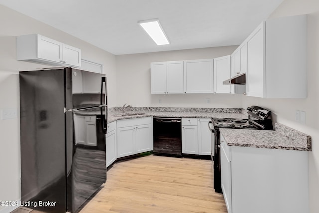 kitchen featuring light stone countertops, black appliances, light hardwood / wood-style flooring, sink, and white cabinetry