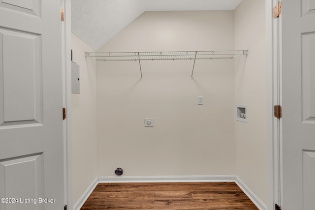 laundry room featuring hookup for a washing machine, hardwood / wood-style flooring, electric dryer hookup, and a textured ceiling