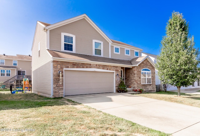 view of front of house with a front yard and a garage