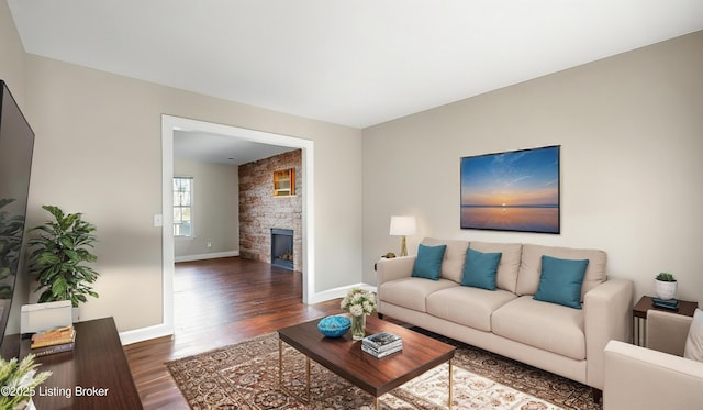 living room with a fireplace and dark hardwood / wood-style floors