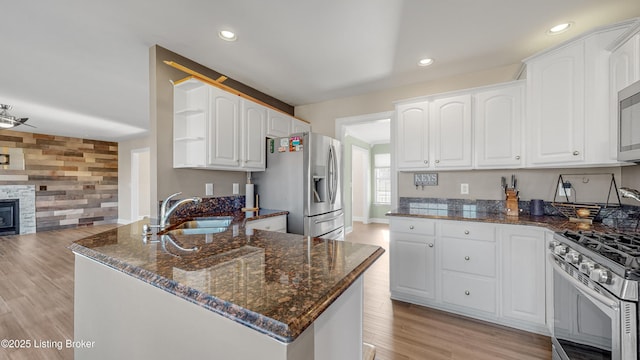 kitchen with white cabinets, appliances with stainless steel finishes, and sink