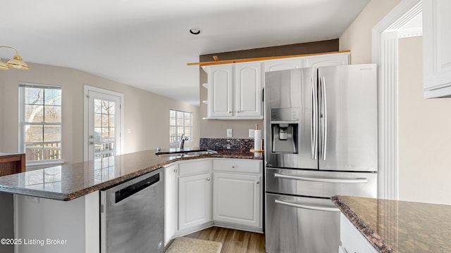 kitchen featuring white cabinets, sink, appliances with stainless steel finishes, and light hardwood / wood-style flooring