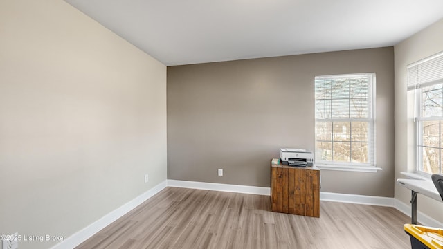 unfurnished office with light wood-type flooring and a wealth of natural light