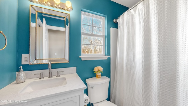 bathroom with vanity, a shower with shower curtain, and toilet