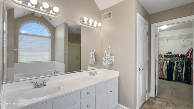 bathroom with shower with separate bathtub, lofted ceiling, and a healthy amount of sunlight