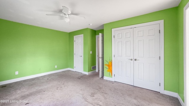 unfurnished bedroom featuring ceiling fan and light colored carpet