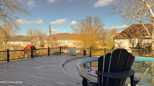 wooden terrace with a fenced in pool