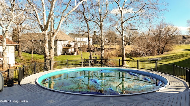 view of pool with a yard