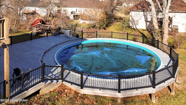 view of swimming pool with a hot tub