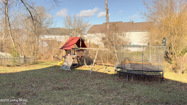 view of yard with a playground and a trampoline