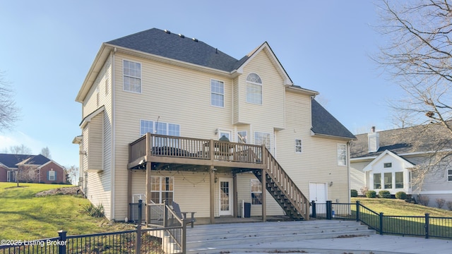 back of house featuring a wooden deck and a yard