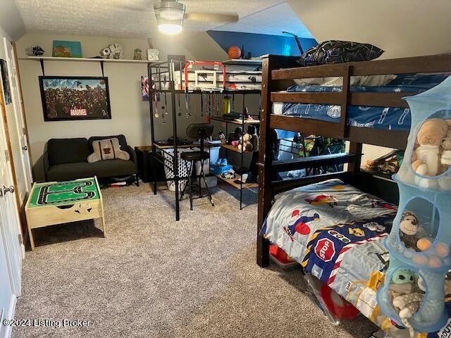 carpeted bedroom featuring a textured ceiling and ceiling fan