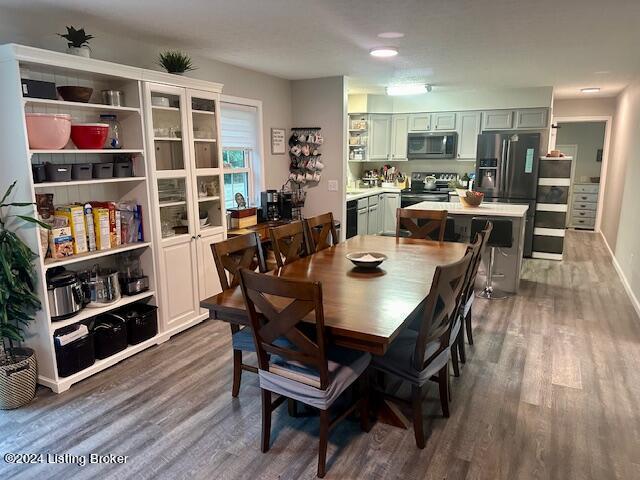 dining space with dark hardwood / wood-style flooring