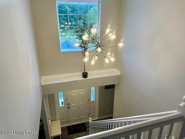 foyer with a notable chandelier and hardwood / wood-style flooring