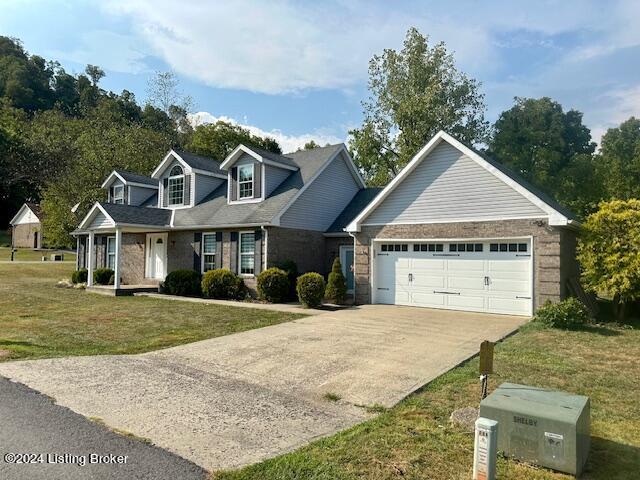 view of front of property with a garage and a front lawn