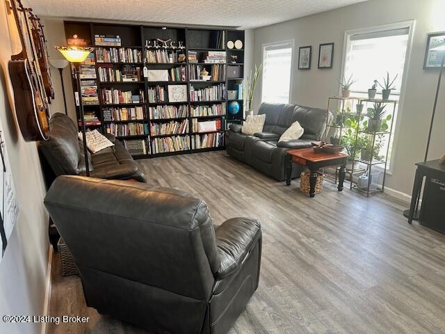 interior space featuring a textured ceiling, a wealth of natural light, and hardwood / wood-style floors