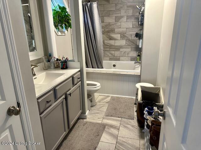 full bathroom with vanity, toilet, and shower / bathtub combination with curtain