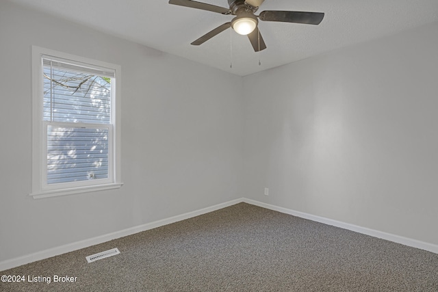 carpeted empty room featuring ceiling fan