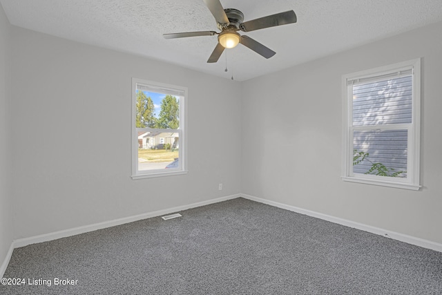 unfurnished room with ceiling fan, carpet, and a textured ceiling