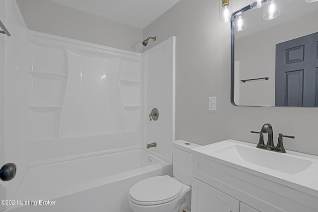 full bathroom featuring a textured ceiling, vanity, toilet, and shower / washtub combination