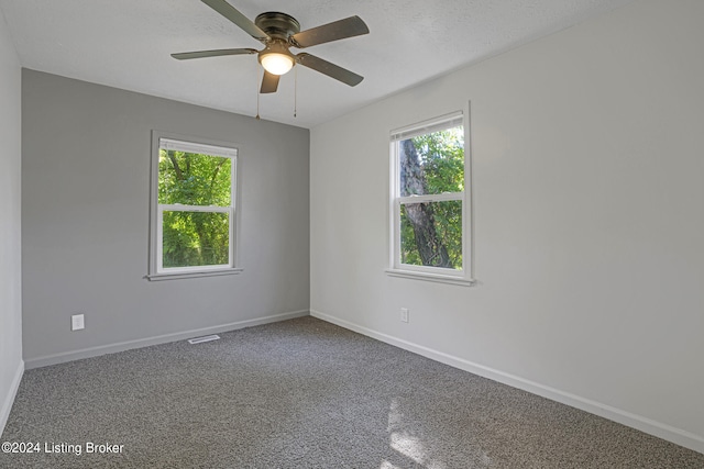 unfurnished room featuring ceiling fan and a textured ceiling