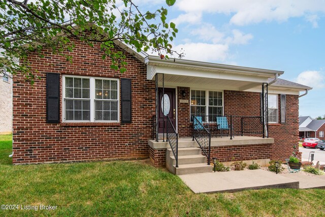 view of front of property with covered porch and a front yard