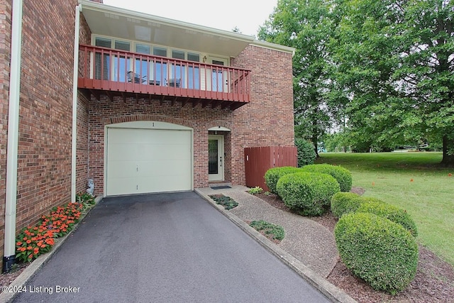 view of front of home with a balcony and a front yard