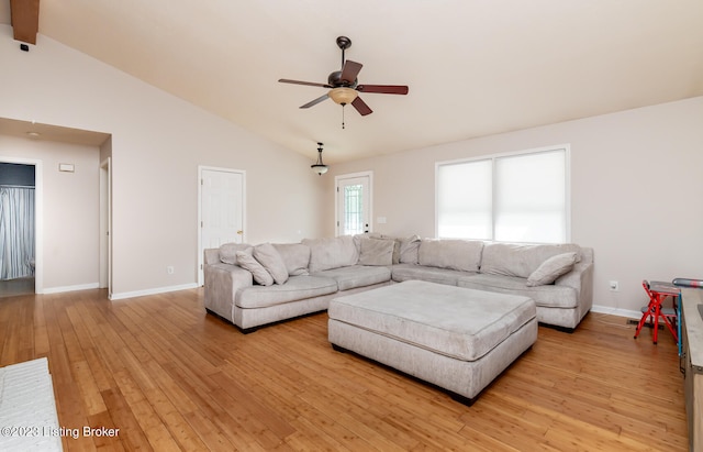 living room with light wood-type flooring, beamed ceiling, high vaulted ceiling, and ceiling fan