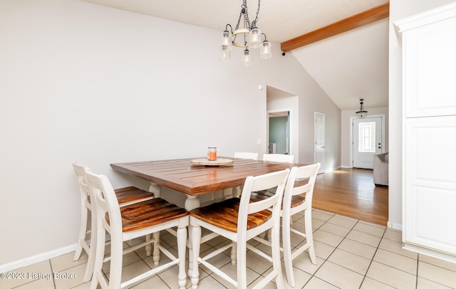 dining room with light wood-type flooring, a chandelier, and vaulted ceiling with beams