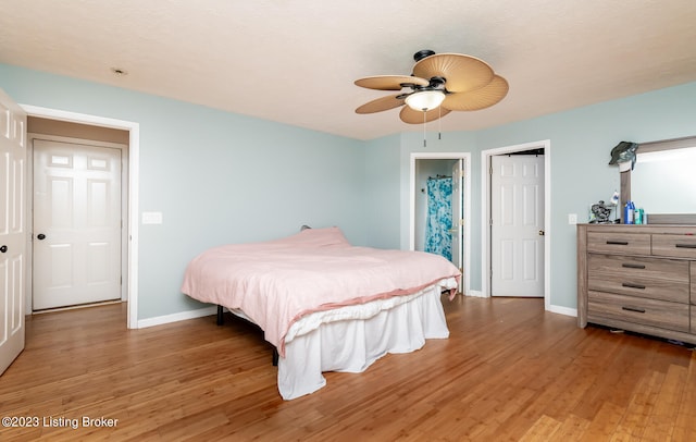 bedroom featuring hardwood / wood-style floors and ceiling fan