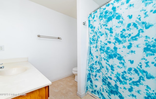 bathroom with tile patterned flooring, vanity, toilet, and walk in shower