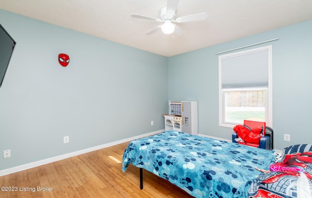 bedroom with light hardwood / wood-style flooring and ceiling fan