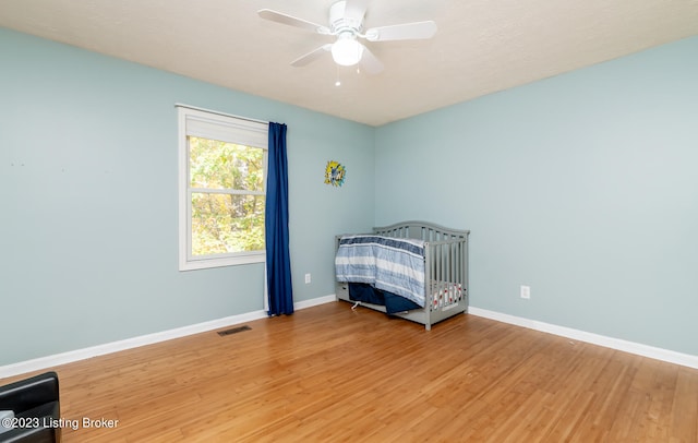 unfurnished bedroom featuring hardwood / wood-style floors and ceiling fan