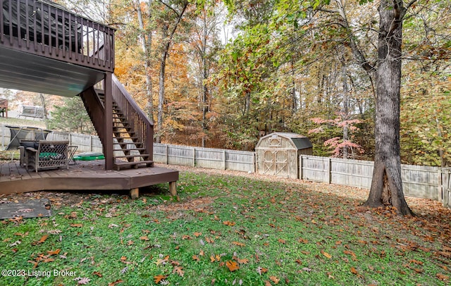 view of yard featuring a deck and a shed