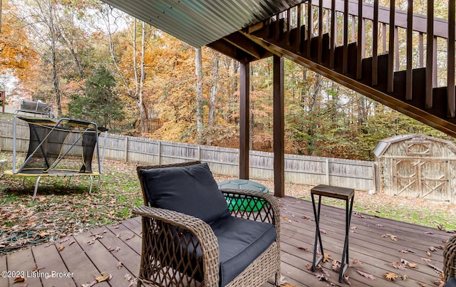 wooden terrace featuring a storage shed