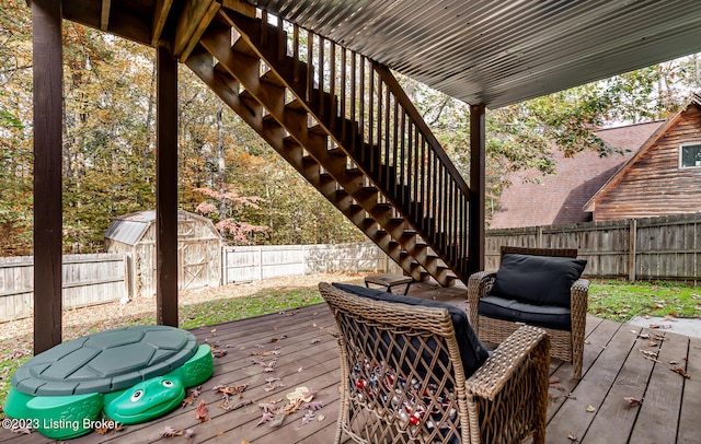 wooden terrace featuring a storage unit