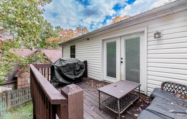 wooden terrace featuring area for grilling and french doors