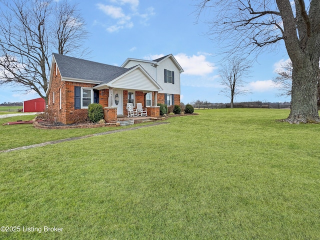 view of front of home featuring covered porch and a front lawn