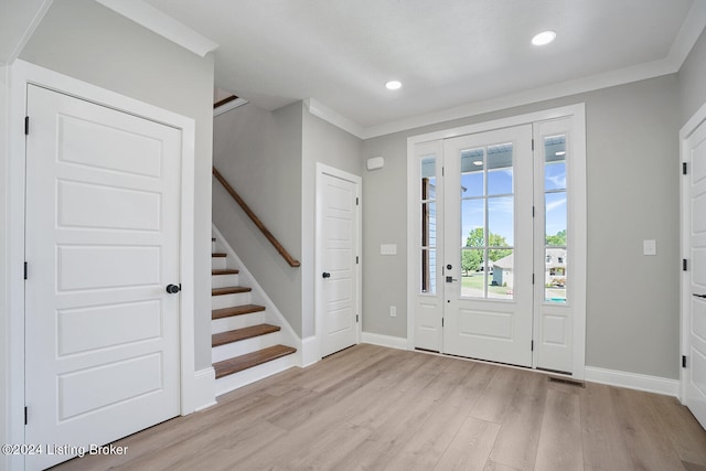 entryway featuring crown molding and light hardwood / wood-style flooring