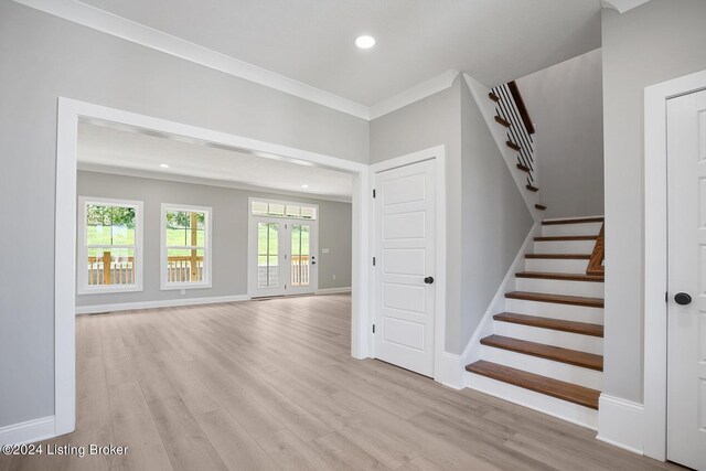 interior space featuring hardwood / wood-style floors and crown molding