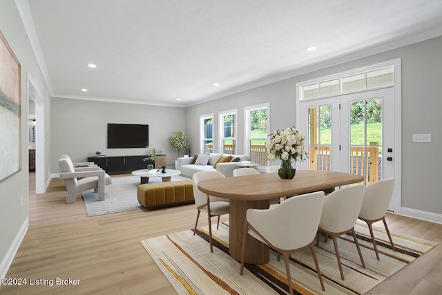 dining area with crown molding, light hardwood / wood-style flooring, and french doors