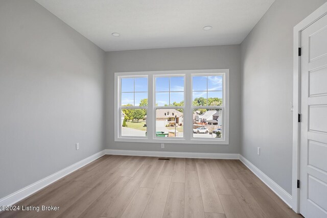 spare room with light hardwood / wood-style floors