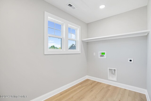 laundry room featuring washer hookup, hookup for an electric dryer, and light hardwood / wood-style floors