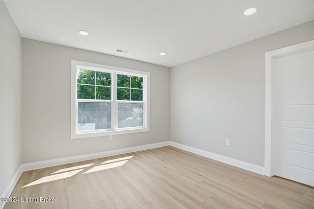 unfurnished room featuring light hardwood / wood-style floors